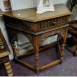 An Old Charm style English oak canted credence table, one drawer to frieze, egg and dart details
