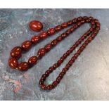 A strand of cherry amber beads (84.7g grosss)