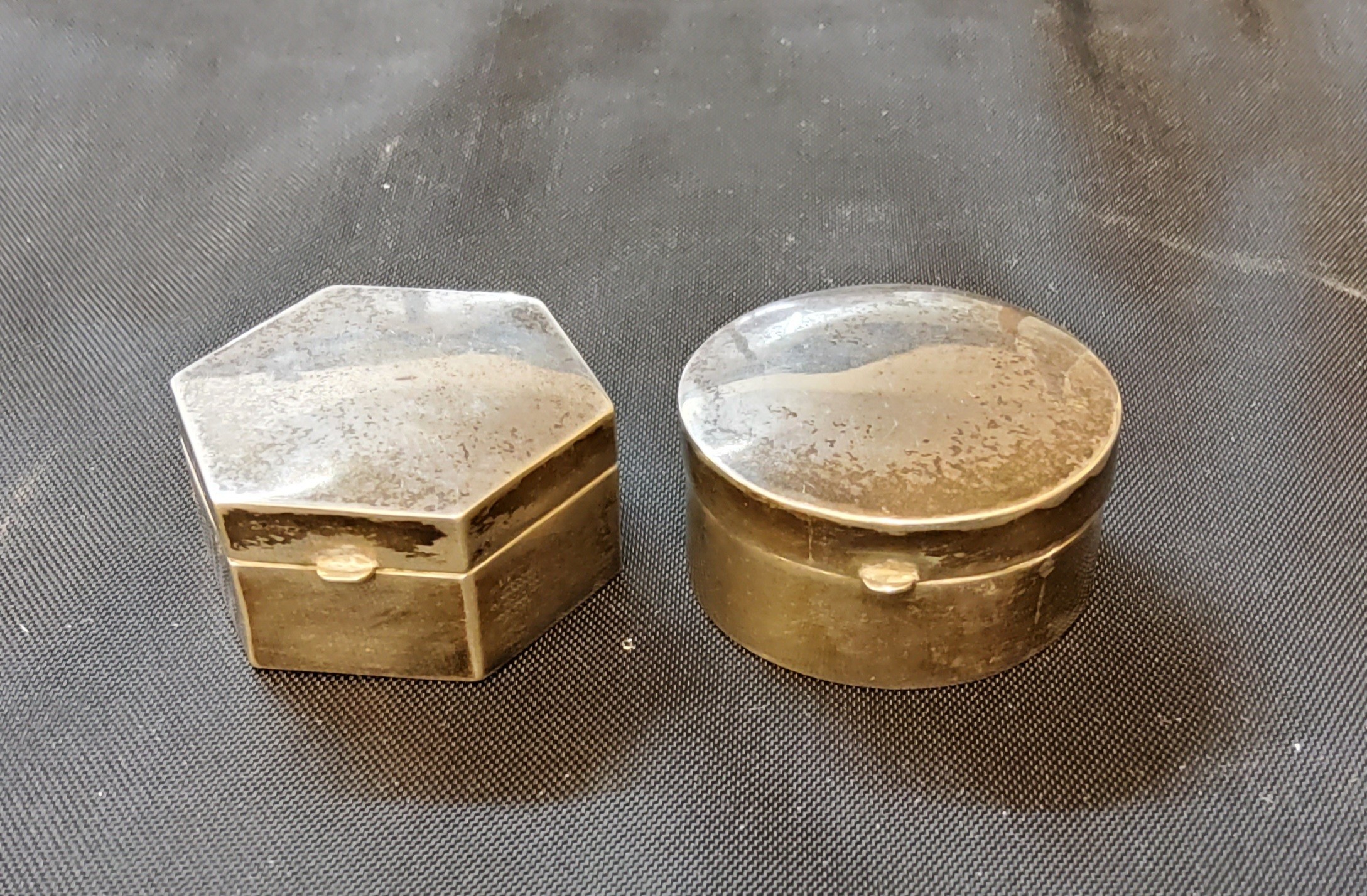 A silver coloured metal circular pin box and cover, stamped 835;  another, hexagonal, 4cm wide (2)