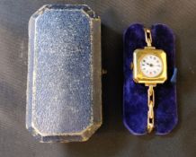 An unsual late 19th/early 20th century 15ct gold lady's watch, the cantered square case with a