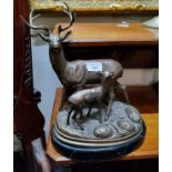 A bronzed resin, Red Deer stag and Fawn, oval faux belge noir marble base, 33cm high
