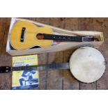 A four-string banjo; Kapok Brand guitar shaped ukulele (2)