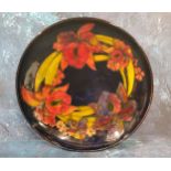 A Moorcroft Flambe Orchid pattern circular bowl, tube lined with flowers and leaves, in tones of red