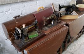 Three Singer sewing machines