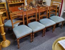 A set of six Edwardian beech dining chairs, profusely carved back supports with turned legs in