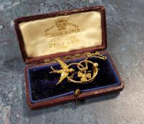 A Victorian yellow metal brooch in the form of a clover leaf & stalk, and a swallow in flight, the
