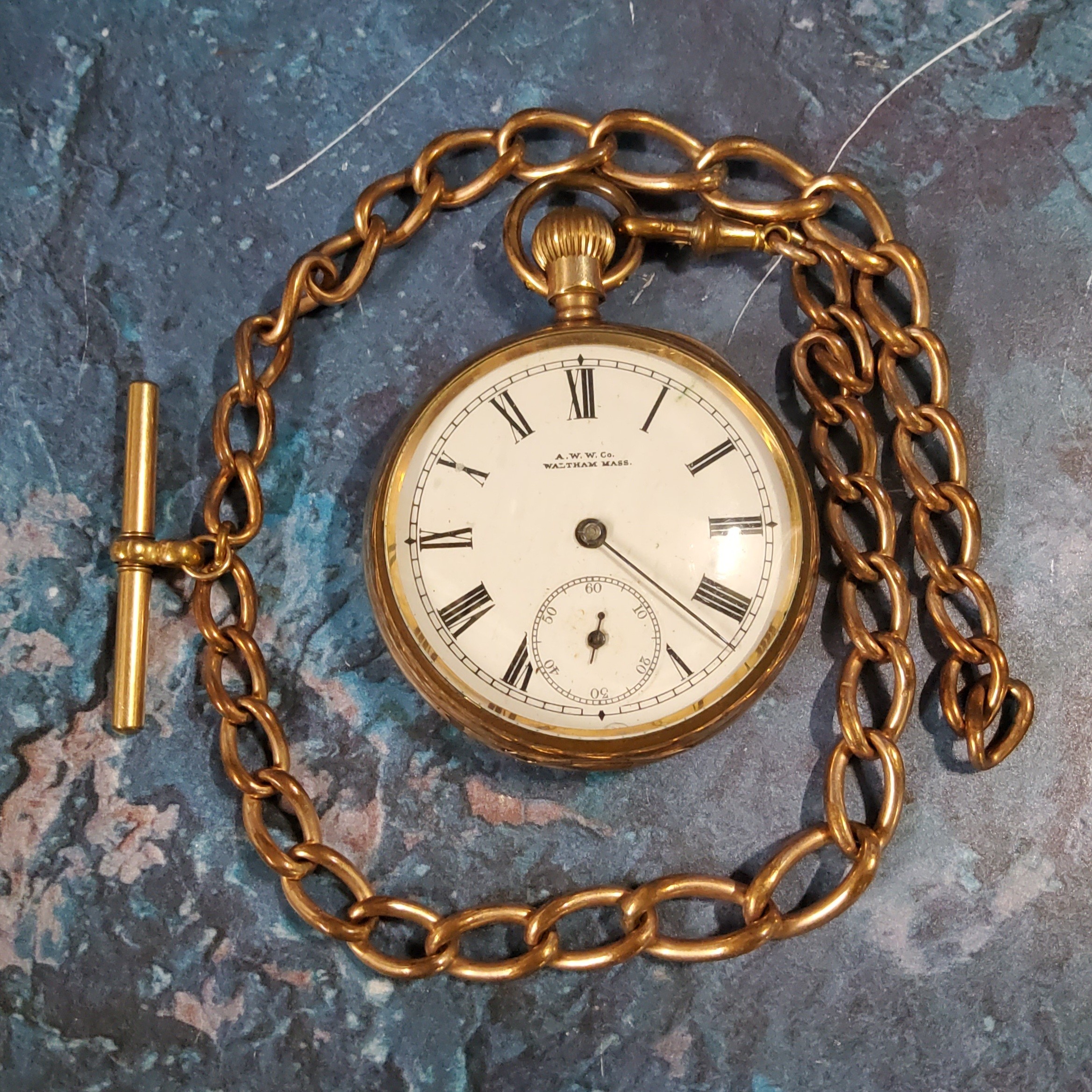 A Waltham gold plated open faced pocket watch;  a gold plated Albert