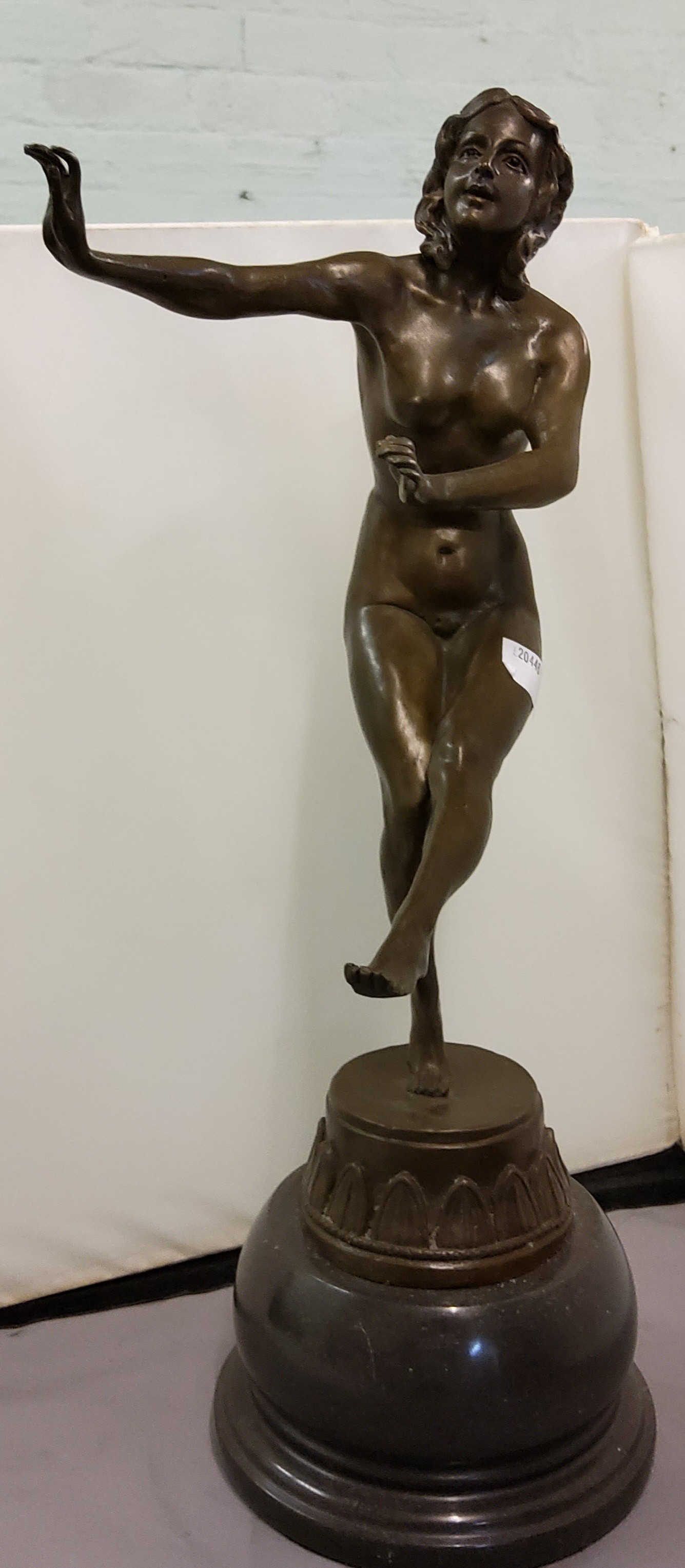 English School, an Art Deco brown patinated bronze, of a Dancer, naked, circular base, 44cm high