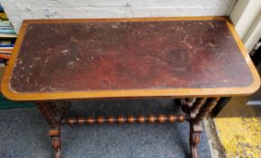 A Victorian rounded rectangular side table, leather top, bobbin turned double columns and stretcher,