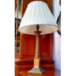 A Corinthian column table lamp with fluted ivory coloured shade