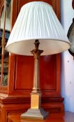 A Corinthian column table lamp with fluted ivory coloured shade