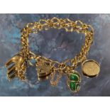 A 9ct gold fancy link charm bracelet with three charms 15.39g gross