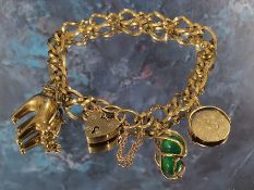 A 9ct gold fancy link charm bracelet with three charms 15.39g gross