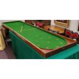 An impressive late 19th century mahogany folding bar billiards game,  with cue, (75cm wide, 136cm