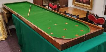 An impressive late 19th century mahogany folding bar billiards game,  with cue, (75cm wide, 136cm