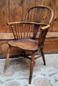 An early 19th century ash and elm Windsor chair, shaped pierced splat with a shaped seat on turned