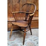 An early 19th century ash and elm Windsor chair, shaped pierced splat with a shaped seat on turned