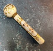 A Victorian porcelain parasol handle, decorated with sheubs within a gilt cartouche, on a white