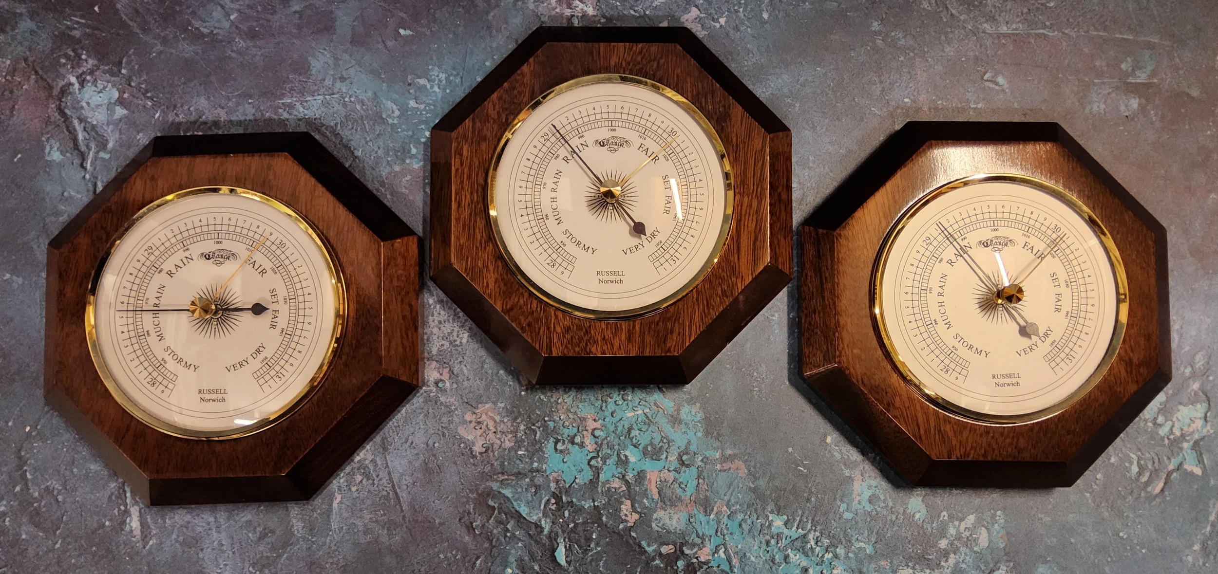 A high gloss mahogany mounted octagonal aneroid barometer, Russell Scientific Instruments; others