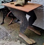 A highly unusual 'folk art' or occult interest cast iron table, the supports as the legs and