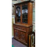 A late Victorian mahogany secretaire cabinet, with moulded cornice above two glazed doors, enclosing