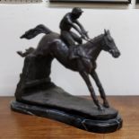 A bronze horse and jockey clearing a fence, veined belge noir marble base, 33cm high