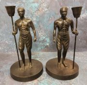 A pair of bronze figural candlesticks, cast as Nubians, holding staffs, 19th century