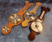 A Woodford mahogany banjo barometer in original packaging; another oak loose; a satinwood banjo