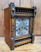 An Arts and Crafts mahogany mantel clock, silver dial with Roman numeral, the rectangular case