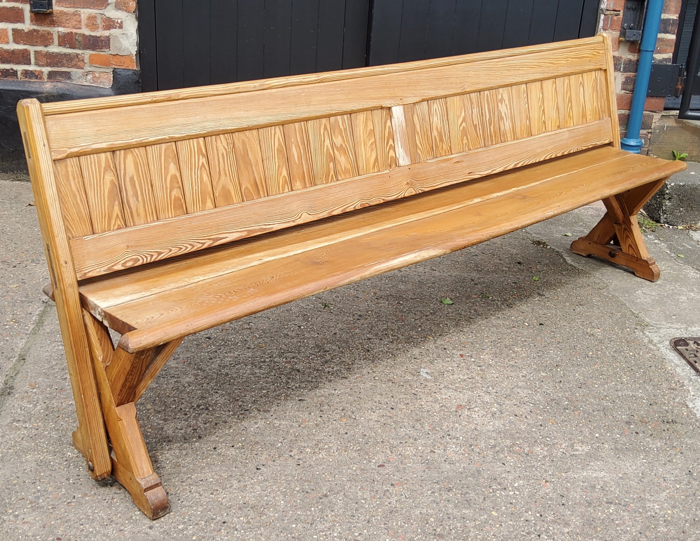 A Victorian pitch pine church pew, slatted back, 240cm long, c,1860