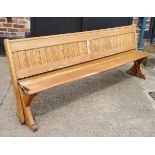 A Victorian pitch pine church pew, slatted back, 240cm long, c,1860