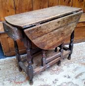 An 18th century English oak drop leaf gateleg tavern table, drawer to frieze, turned supports c.