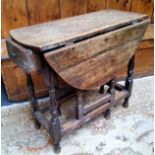 An 18th century English oak drop leaf gateleg tavern table, drawer to frieze, turned supports c.