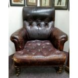 A Victorian leather arm chair, button back and seat, scroll arms, turned mahongay legs, c.1860