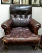 A Victorian leather arm chair, button back and seat, scroll arms, turned mahongay legs, c.1860