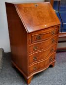 A Reprodux burr walnut serpentine bureau,  of small proportion,  by Bevan Funnell Ltd