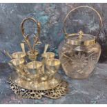 A 19th century plated ware egg stand, six cups and spoons, posted loop handle, pierced scroll