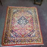 A late 19th/ early 20th century Afghan rug in rich tones of red, gold and blues