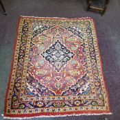 A late 19th/ early 20th century Afghan rug in rich tones of red, gold and blues