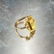 An unusual Victorian 18ct gold ring the large shaped setting centrally set with round diamond