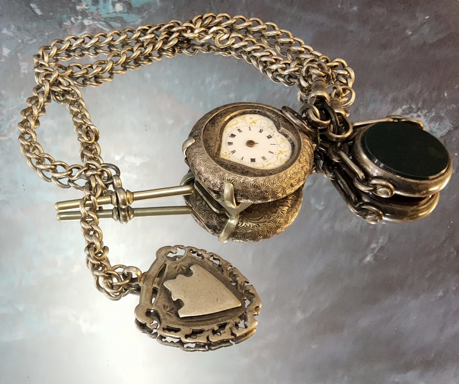 A continental silver lady's open faced fob watch, unusual heart shaped dial aperture, import