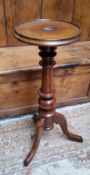 A mahogany torchere, circular top, turned column, tripod legs, 75cm high