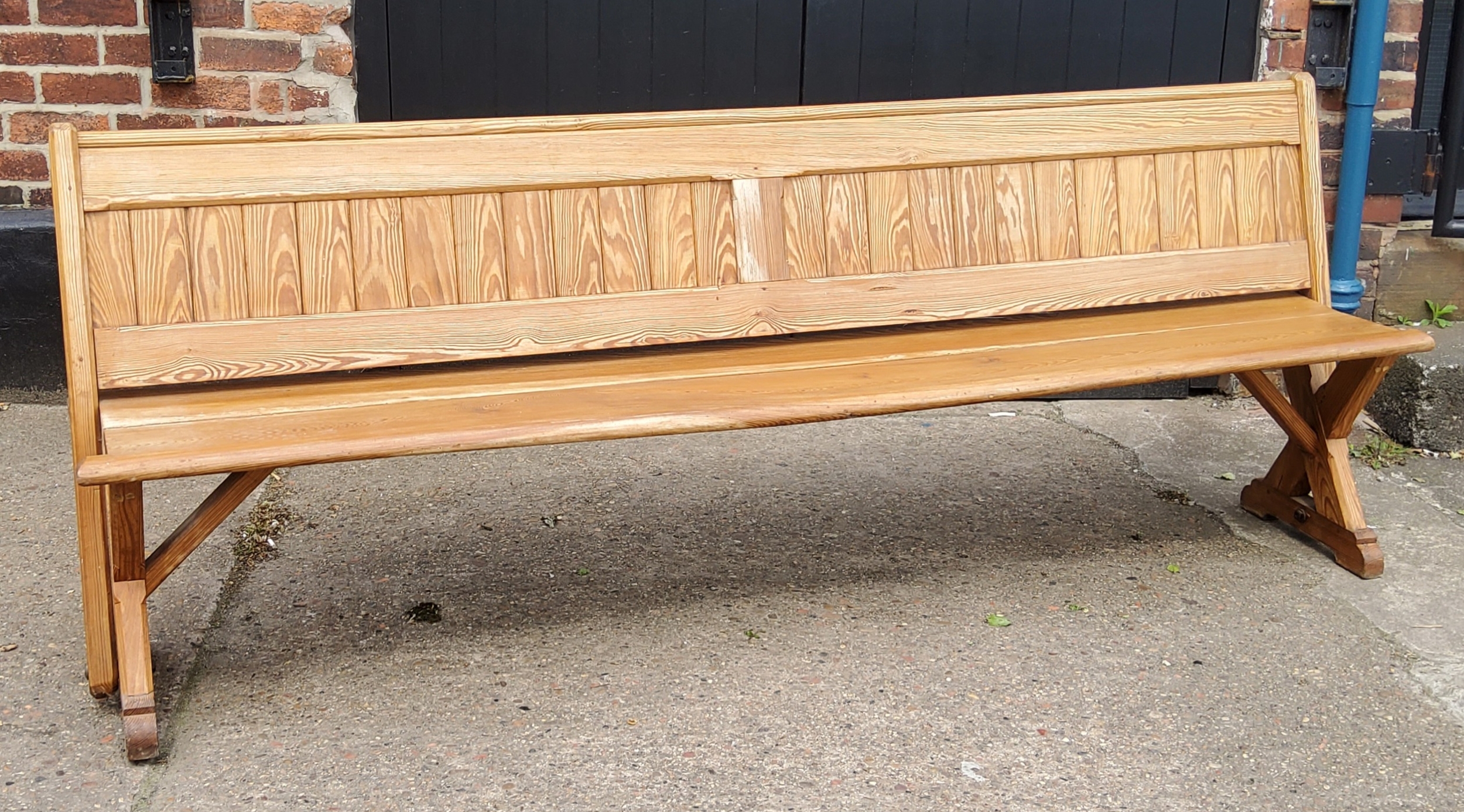 A Victorian pitch pine church pew / tram seat, slatted back, 240cm long, c,1860