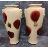 A pair of Japanese tapering cylindrical pottery vases, decorated in sang de beouf with dripped