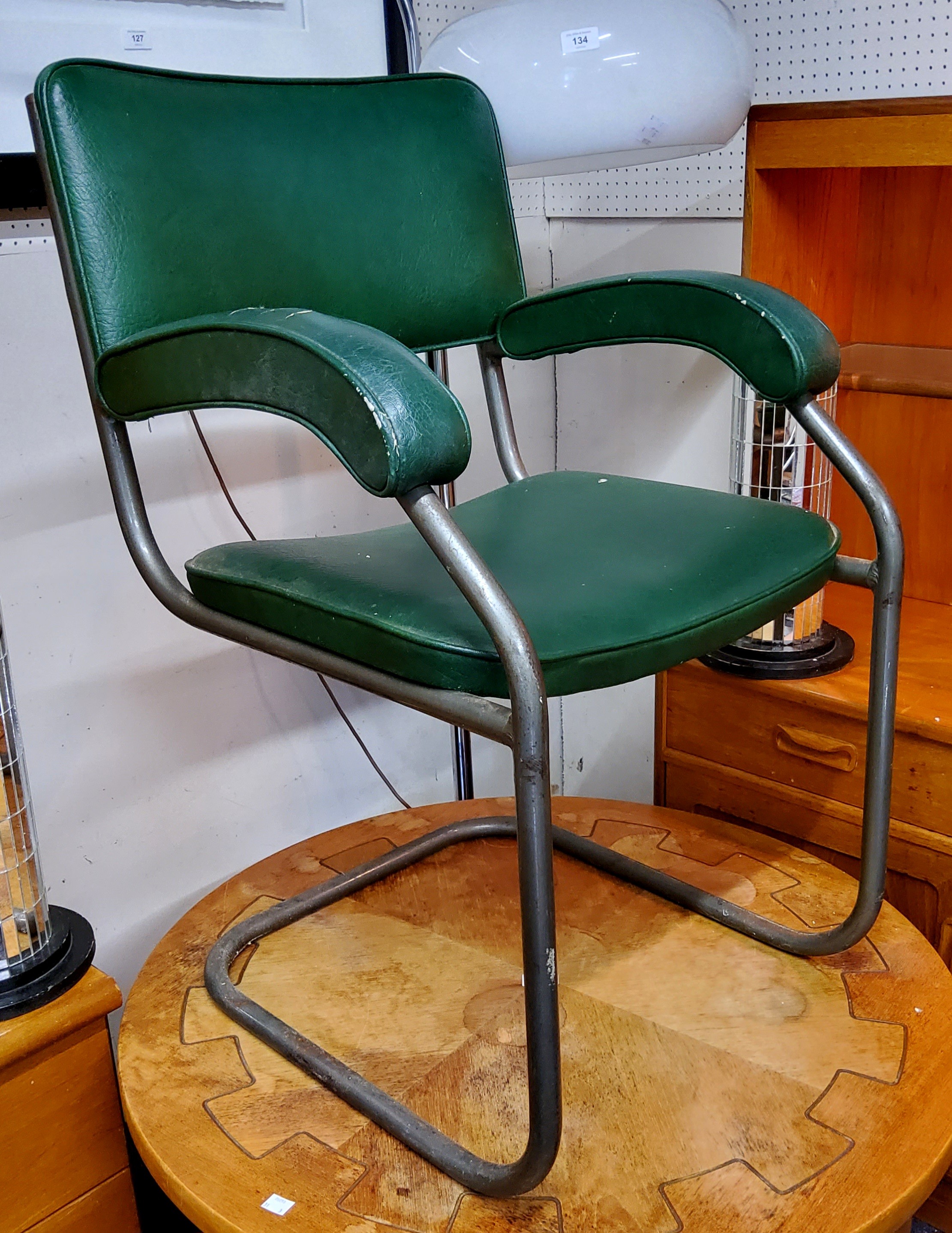 A Modernist  tubular chrome and faux green leather office chair, mid 20th century