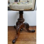 A William IV walnut piano stool, tapestry seat, turned column with trio of acanthus capped