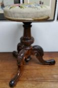 A William IV walnut piano stool, tapestry seat, turned column with trio of acanthus capped