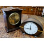 An early 20th century mahogany mantel clock, the 14cm brass dial with Arabic numerals, twin