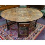 An early George III English oak gateleg drop leaf dining table, pegged construction, single drawer