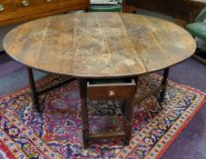 An early George III English oak gateleg drop leaf dining table, pegged construction, single drawer